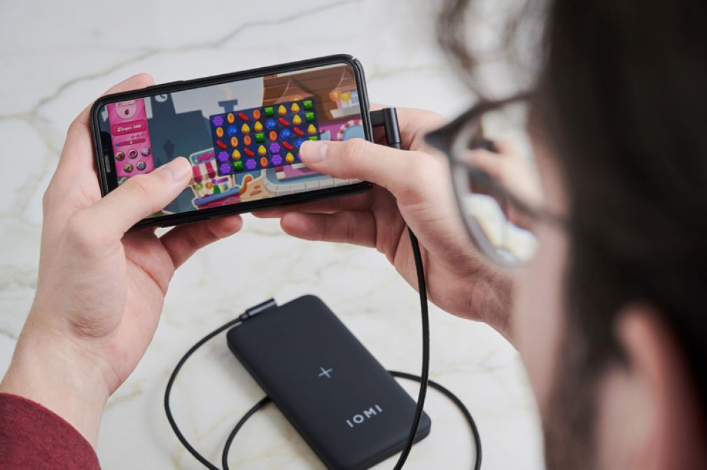 Gaming unter freiem Himmel: Einer der vielen "dringenden" Anwendungsfälle, bei denen ein mobiler Stromspeicher gefordert ist. Bei IOMI gibt es dazu eine weitere Eigenentwicklung - ein Kabel mit 90-Grad-Stecker, um Hand und Finger frei fürs Bedienen des Handys zu haben.